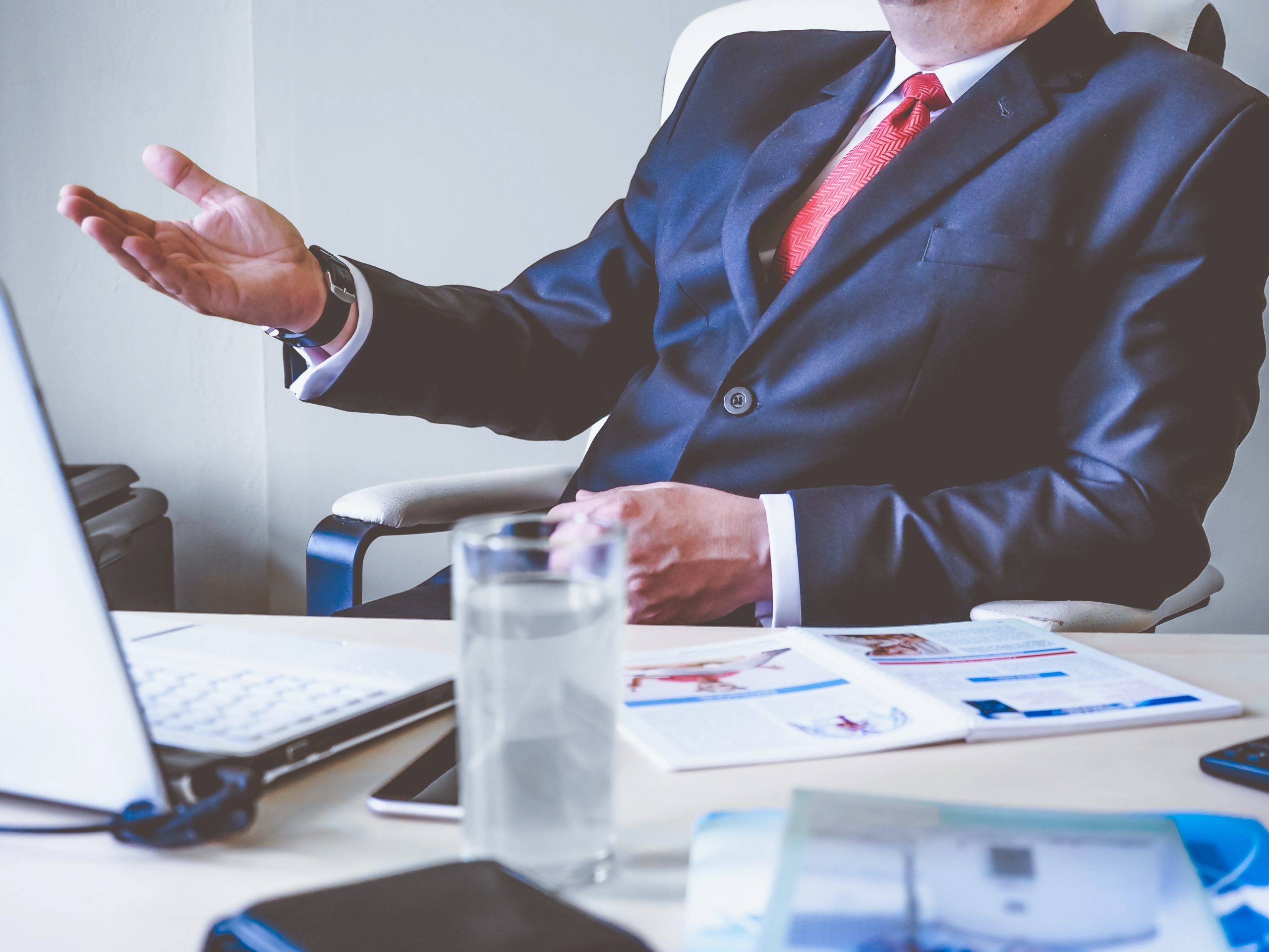 Businessperson gesturing during meeting