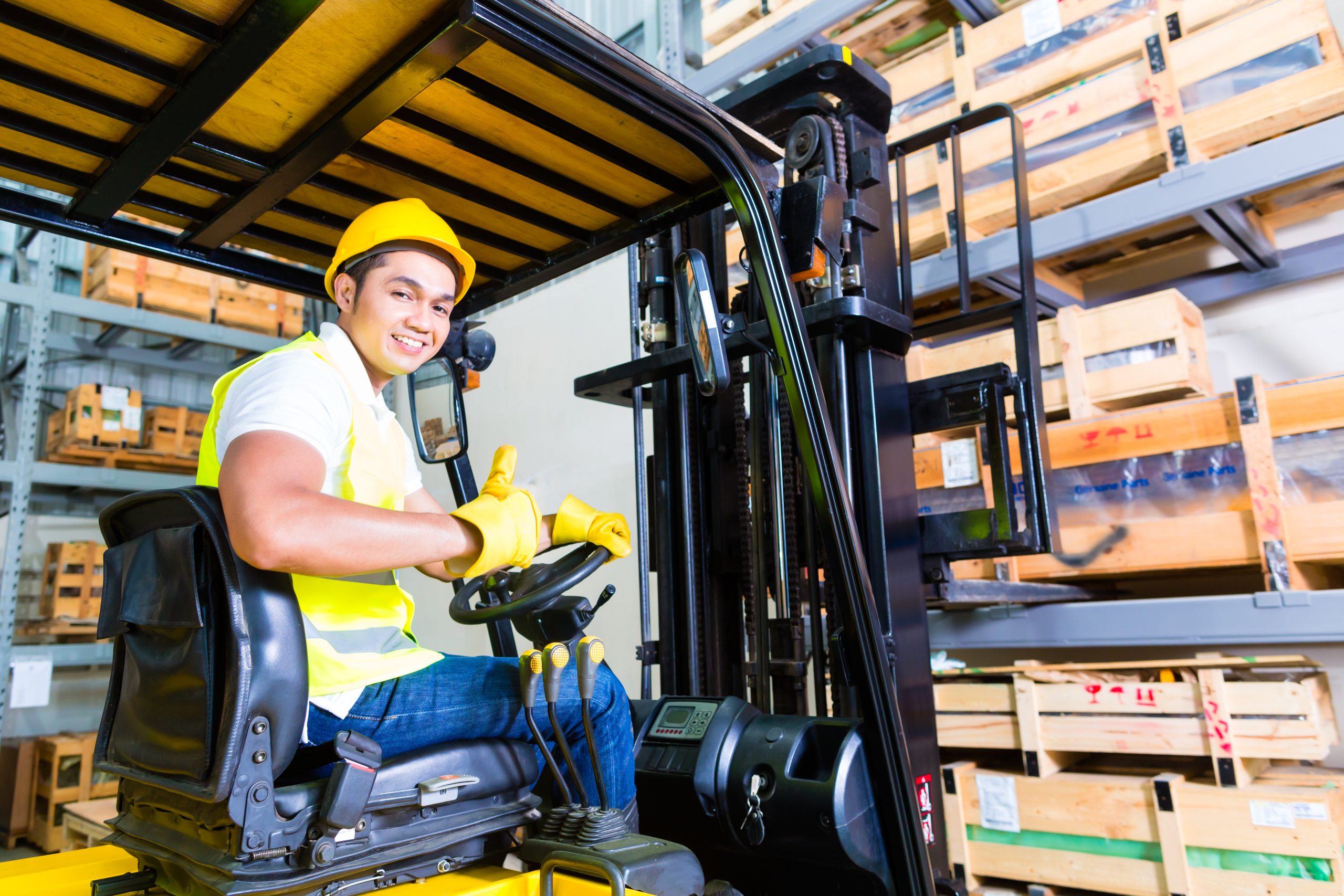 Industrial warehouse worker with forklift and shelving