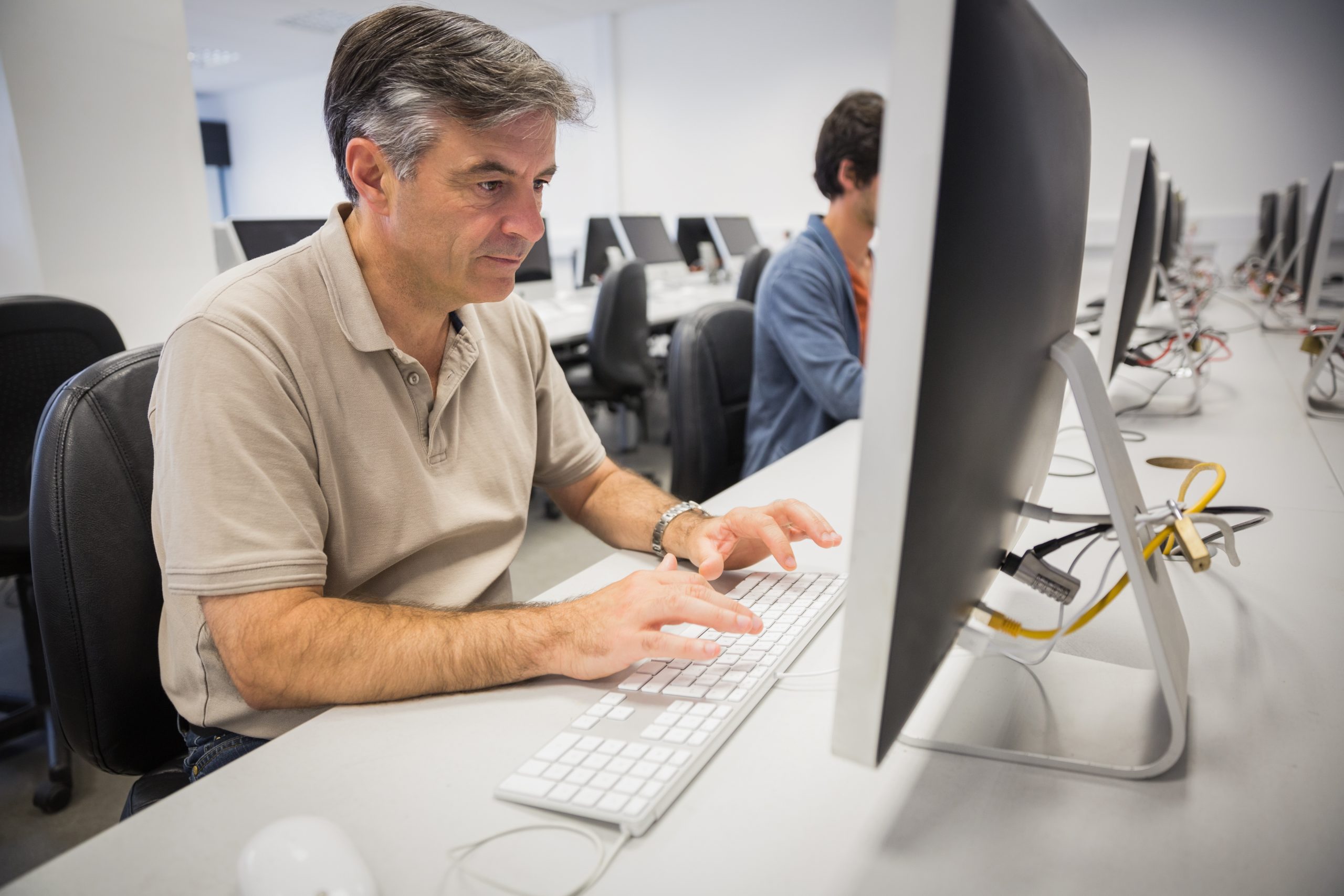 Man using computer at desk in office setting