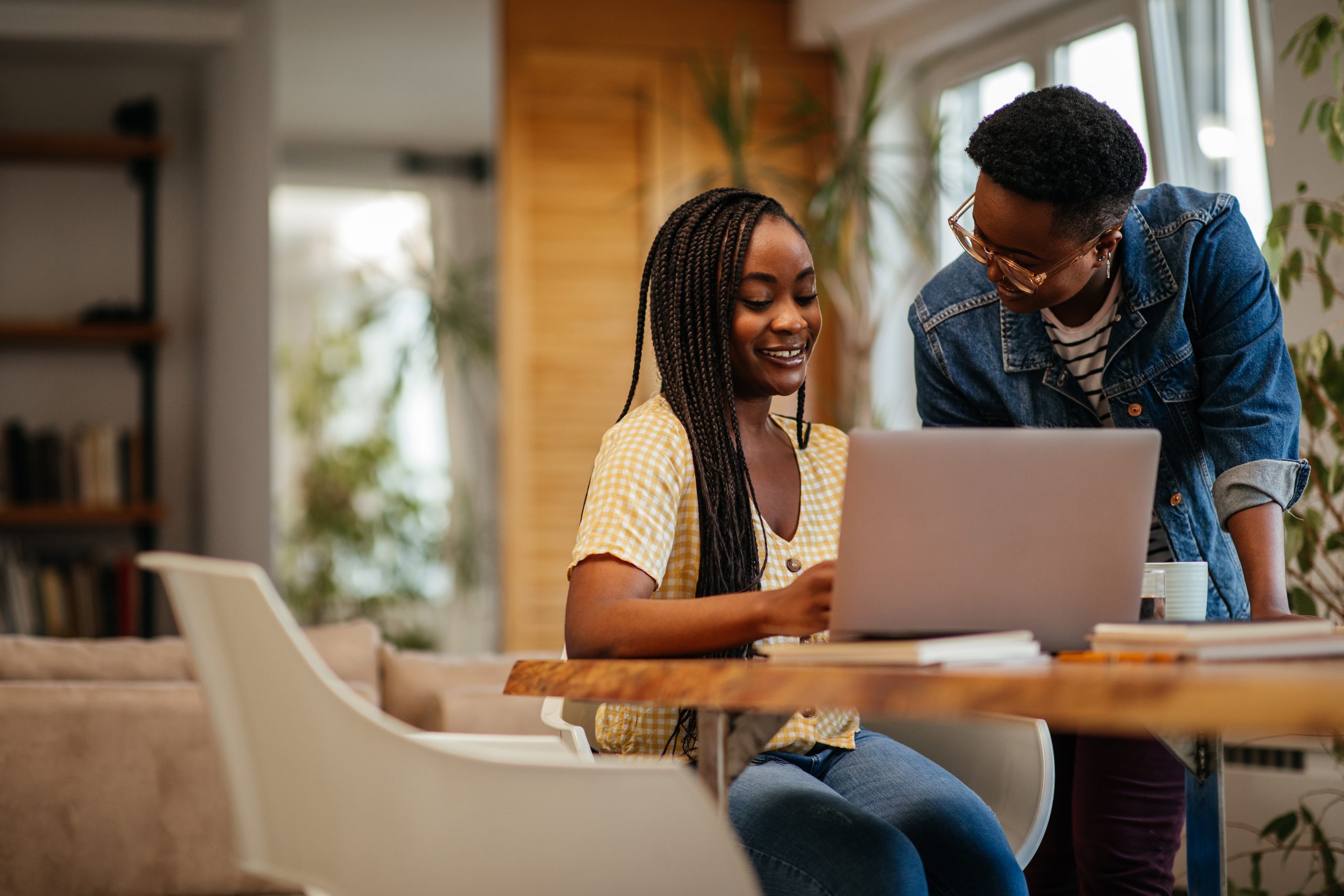 Group of young adults working together on a laptop
