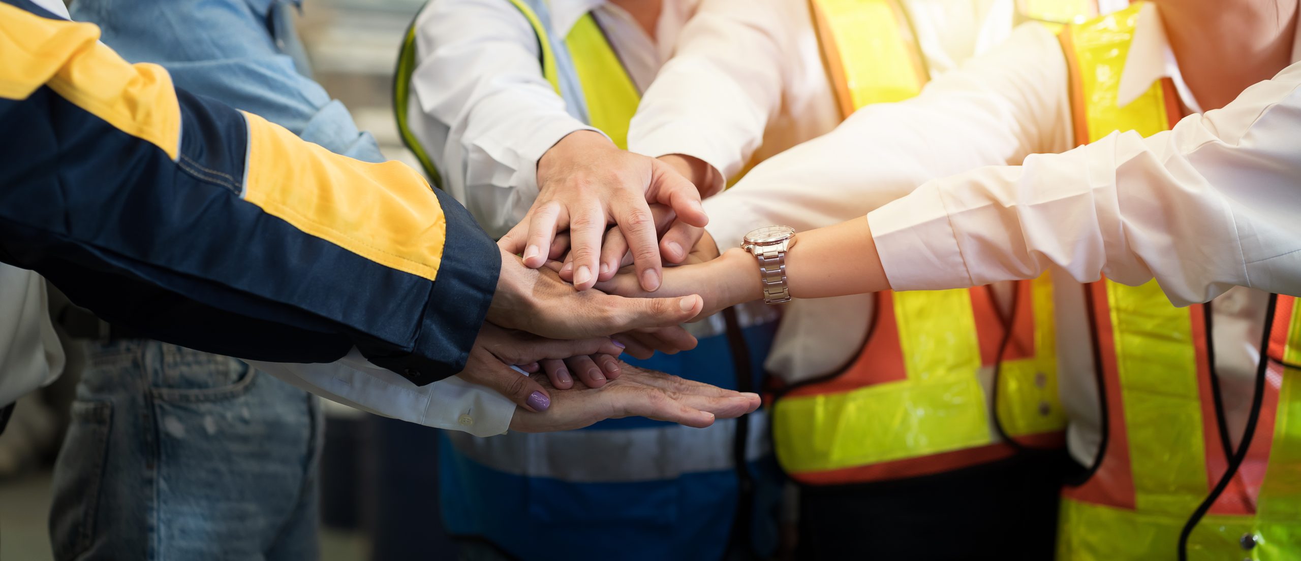 Team stacking hands in a show of collaboration