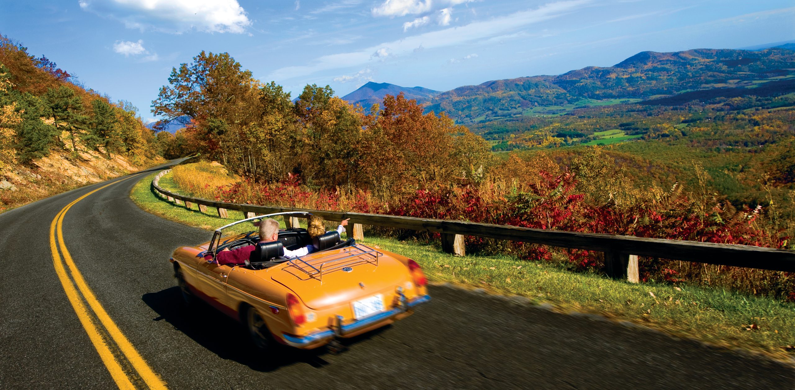 Scenic road with fall foliage and mountains