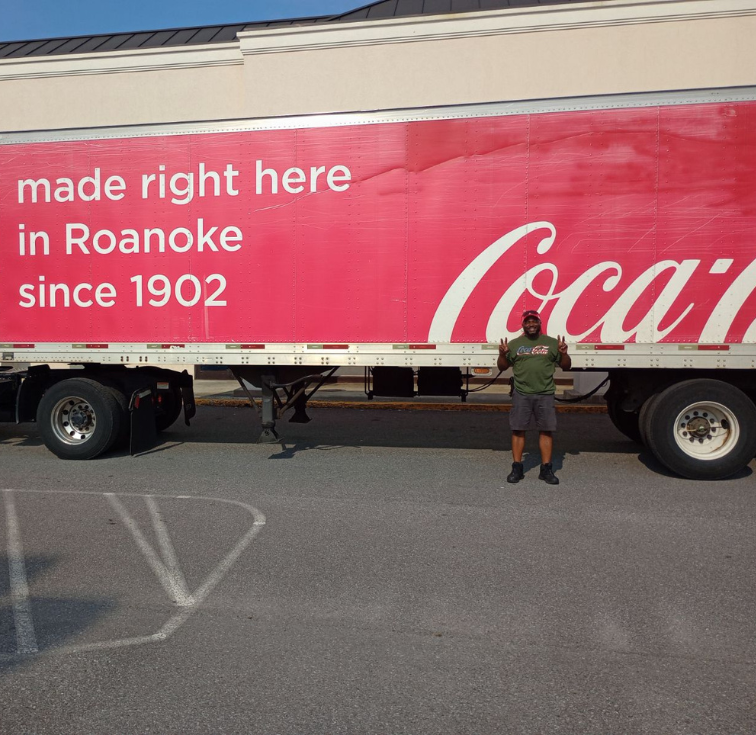 Delivery truck man with Coca-Cola branding on street
