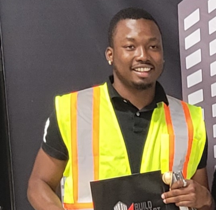 Construction worker in safety vest holding clipboard