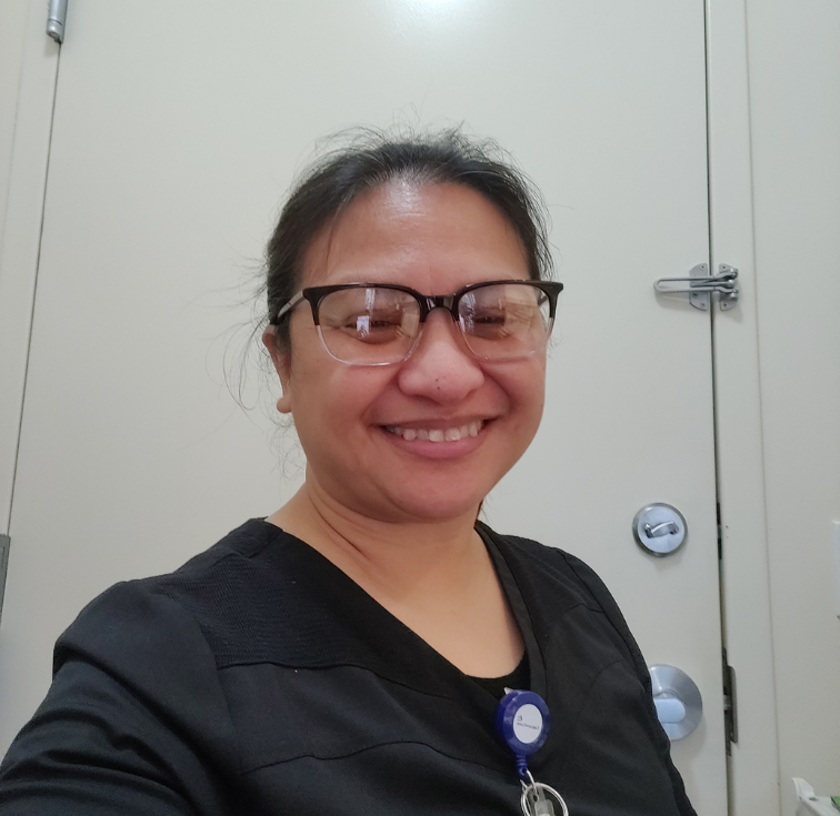 Healthcare worker smiling in clinical setting