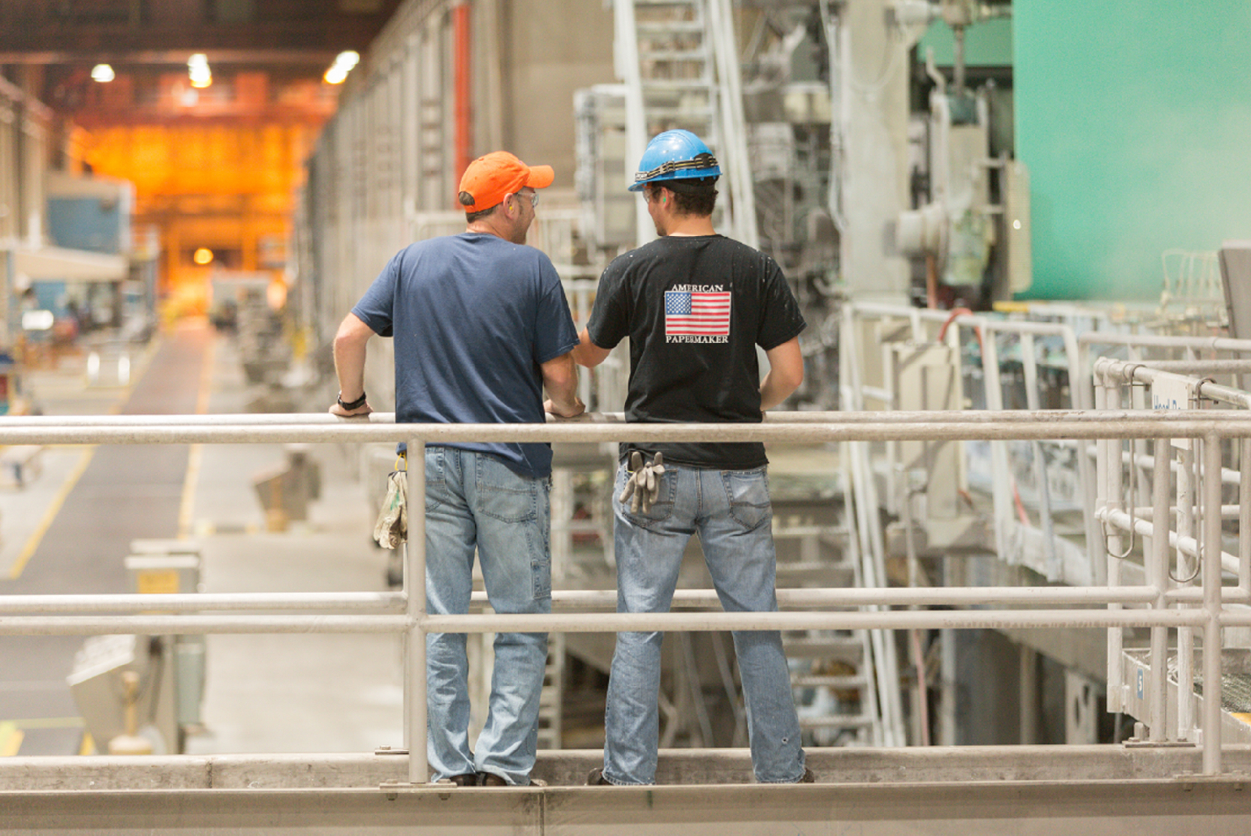 Workers operating machinery in facility