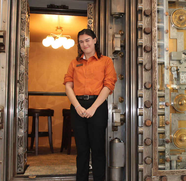 Worker standing in front of vault door