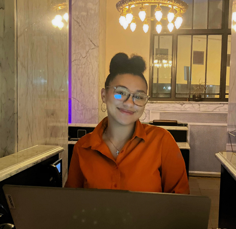 Woman smiling at desk with laptop