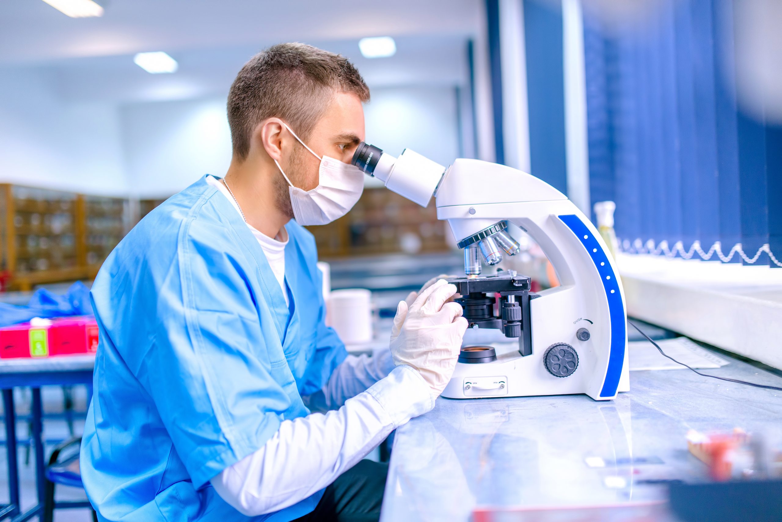 Scientist using microscope in lab