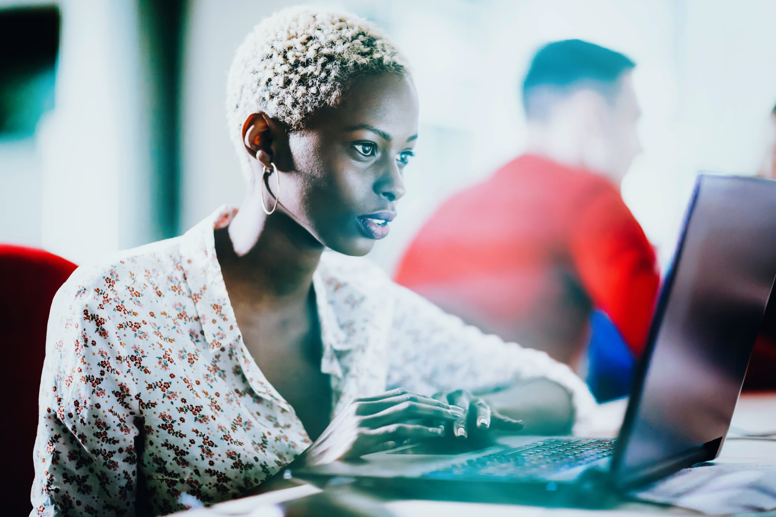 Woman working on a laptop in a modern office