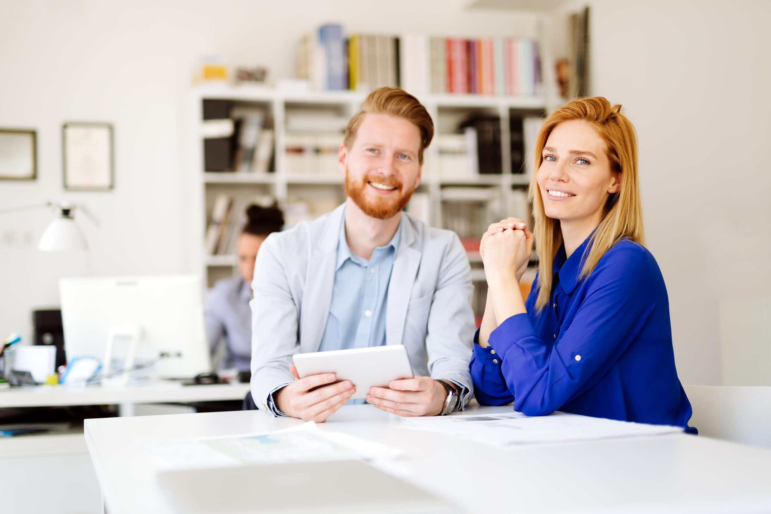 Two professionals meeting at desk