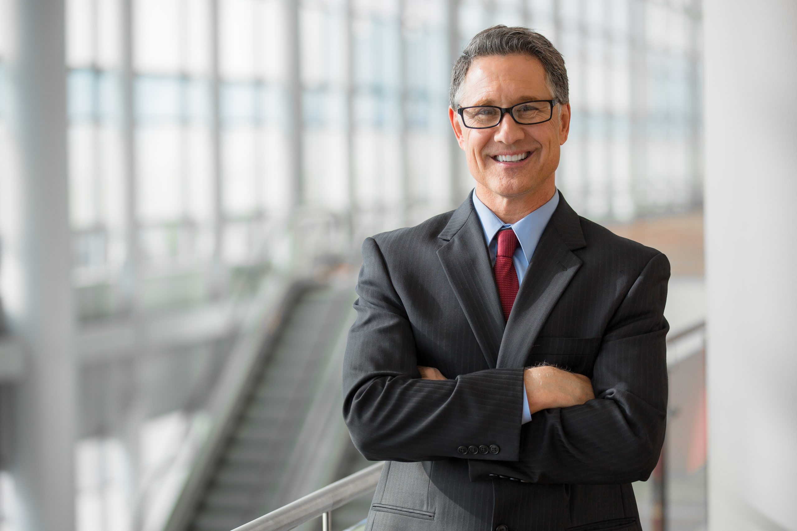 Business professional standing with arms crossed