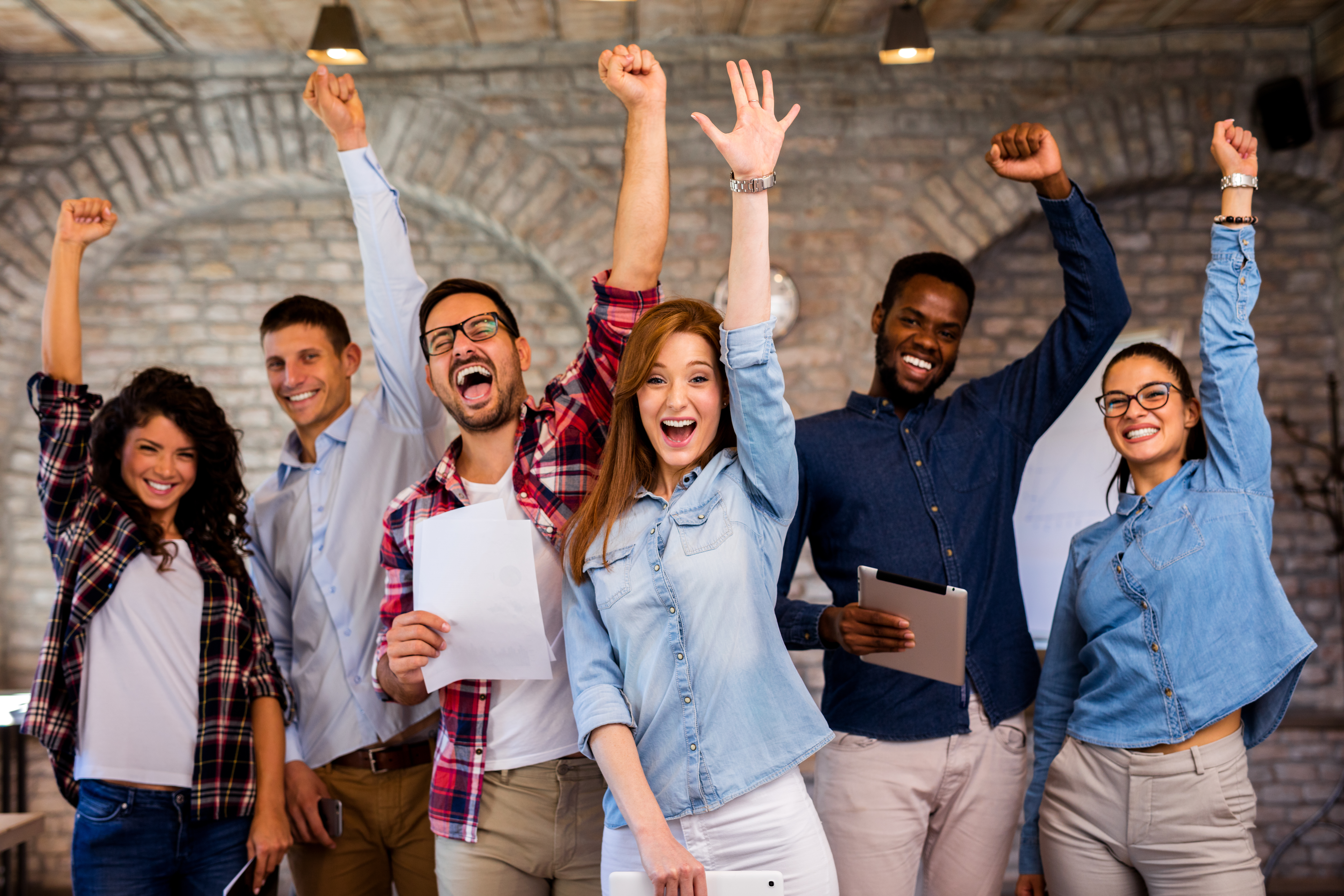 Group celebrating success in office